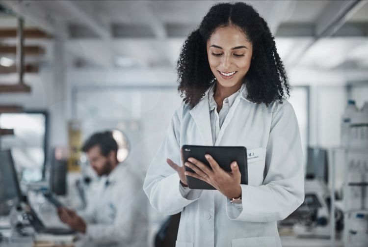 Researcher in a lab using a tablet