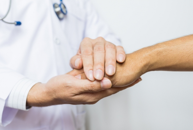 doctor holding patient's hand