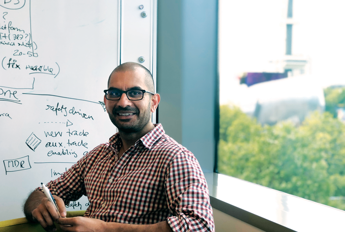 Omar Vandal in front of a whiteboard