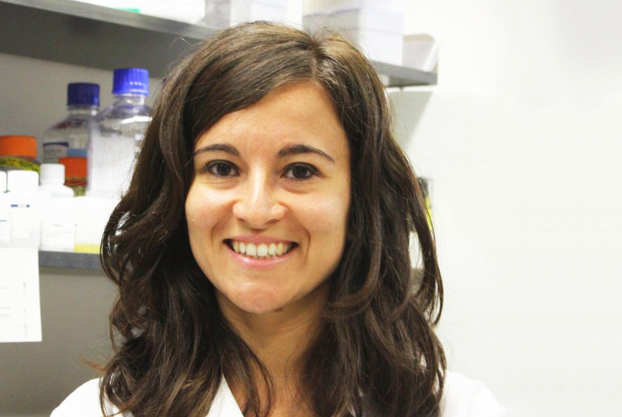 a woman in a white coat posing for a photo
