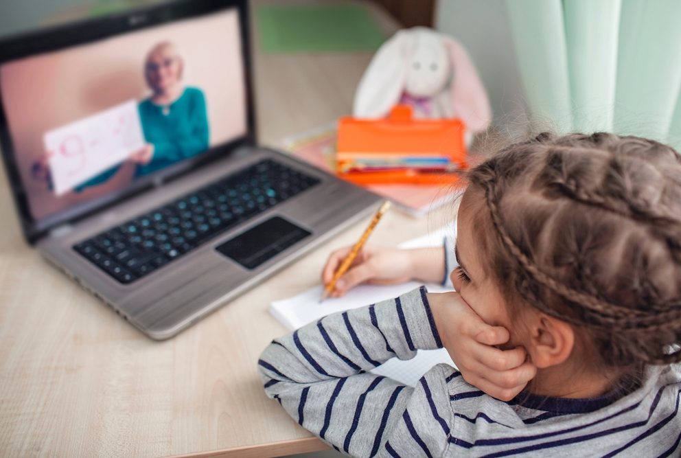 Young girl attending an online class