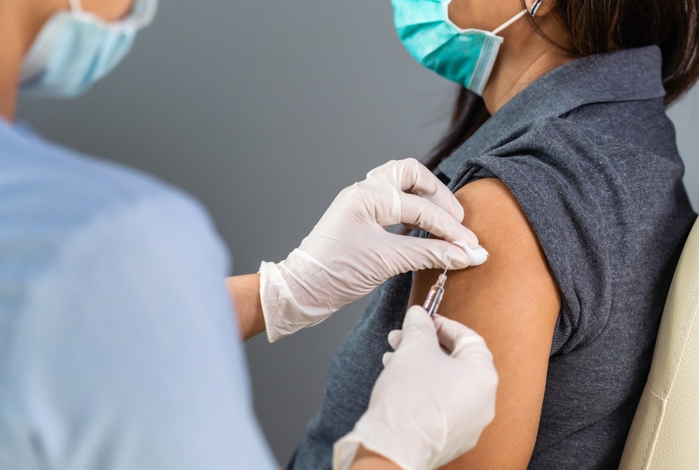 A patient at the doctor's office getting a vaccine shot.