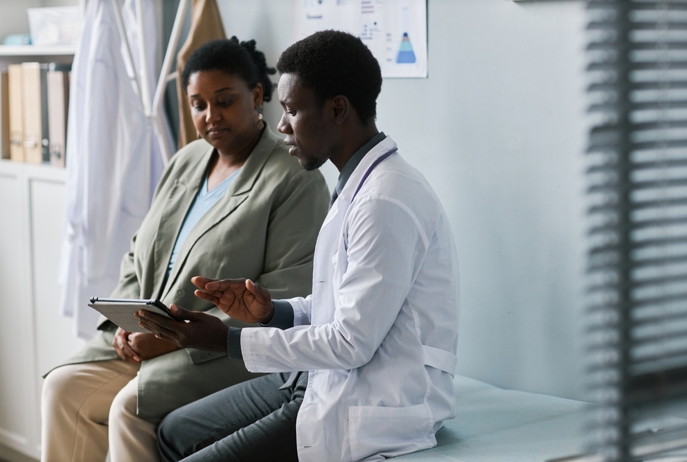 doctor showing patient info on a tablet