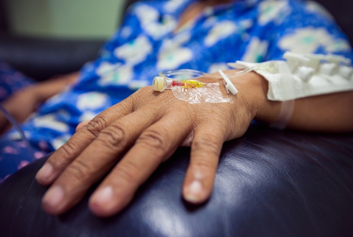 hand with needle for IV infusion