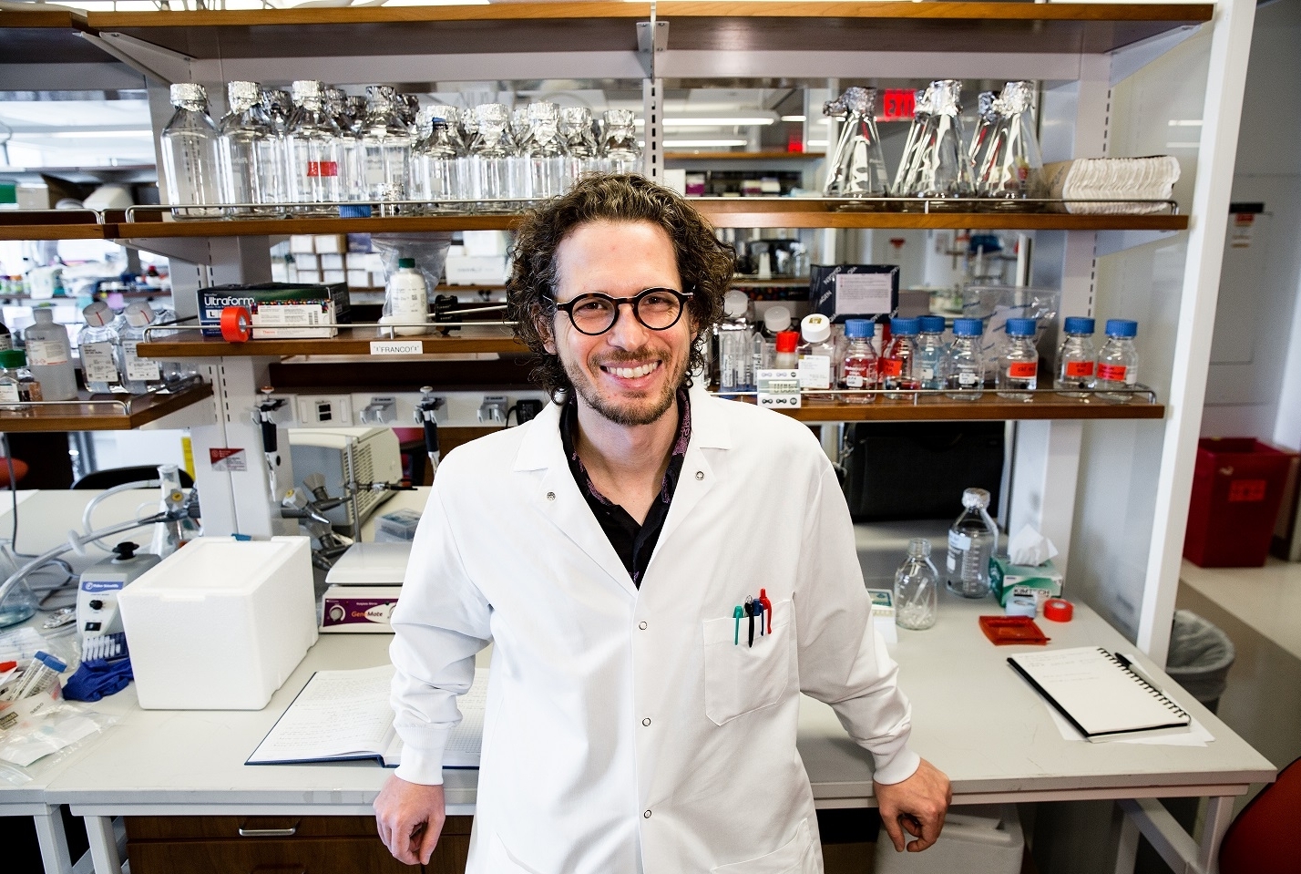 a man in a lab posing for a portrait.