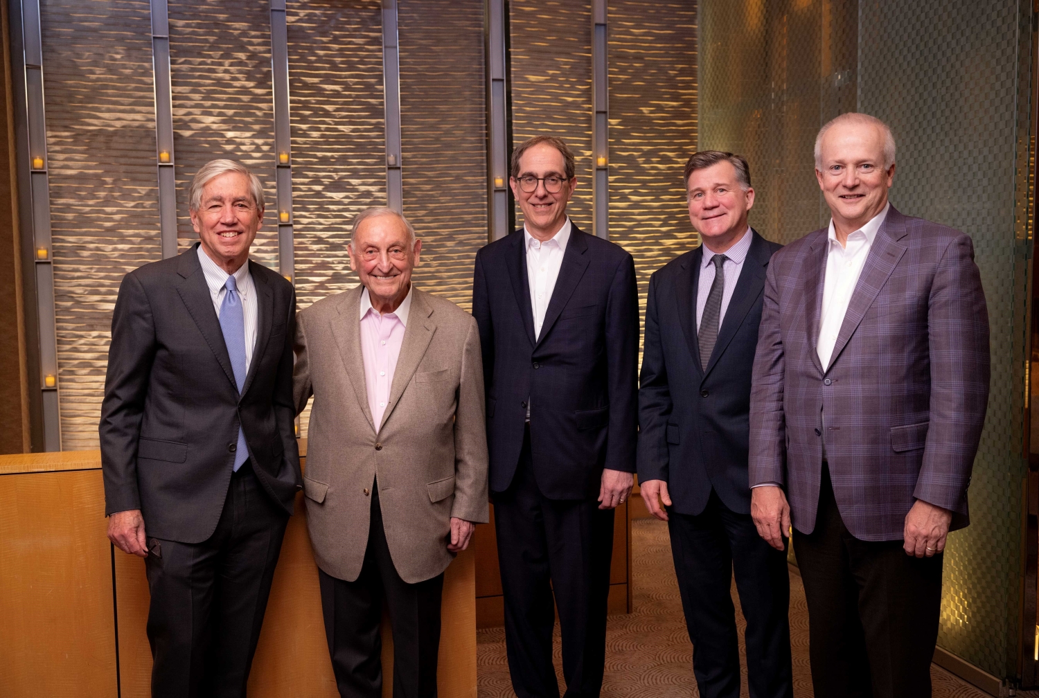 Five men standing together for a group photo