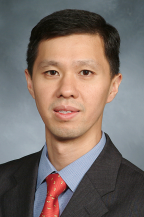 a man in a suit posing for a picture