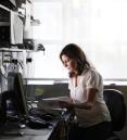 Woman sitting at desk and reading