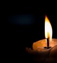 photo of a candle burning in the dark