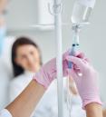 doctor preparing infusion for female patient