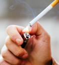 A person lighting a cigarette