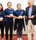 Flora Baik, Daly Avendano and Shu Lei pose holding awards with Dr. Anthony Brown