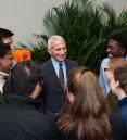 students gathered around Dr. Anthony Fauci following his documentary screening at a medical institution